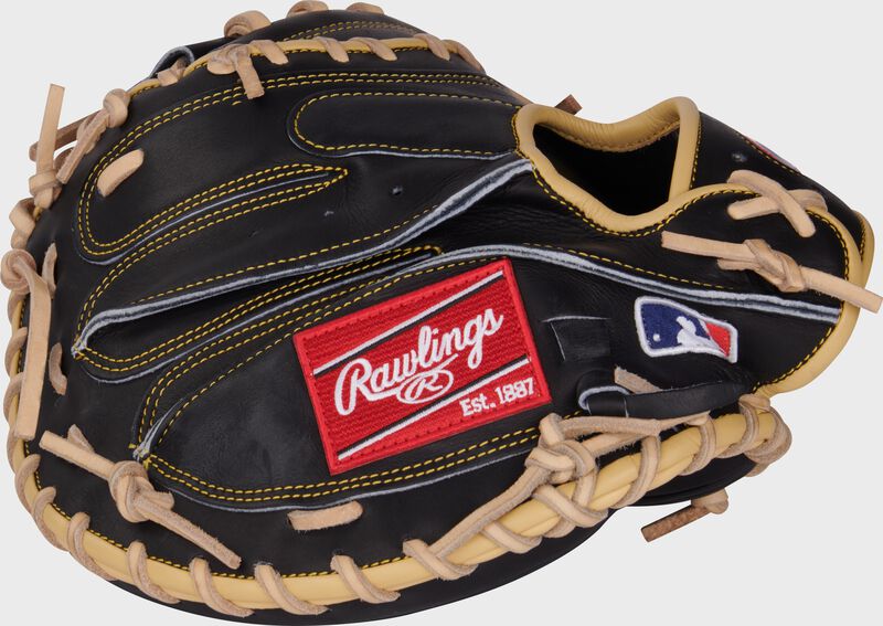 Back of a black Adley Rutschman Heart of the Hide catcher's mitt with a red Rawlings patch and MLB logo on the pinky