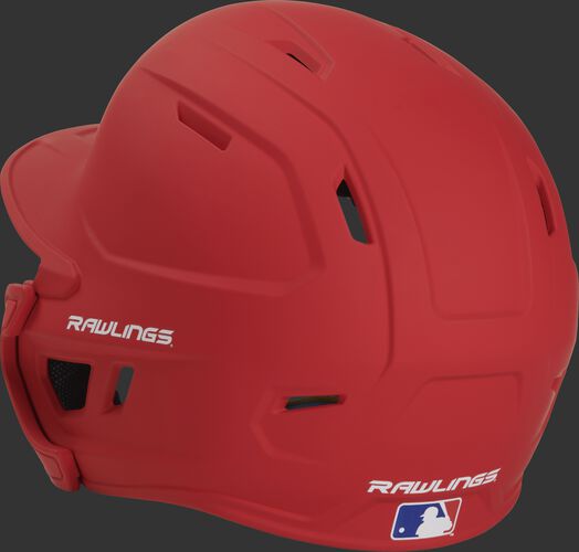 Back left view of a matte scarlet MACHEXTR MACH series batting helmet with air vents