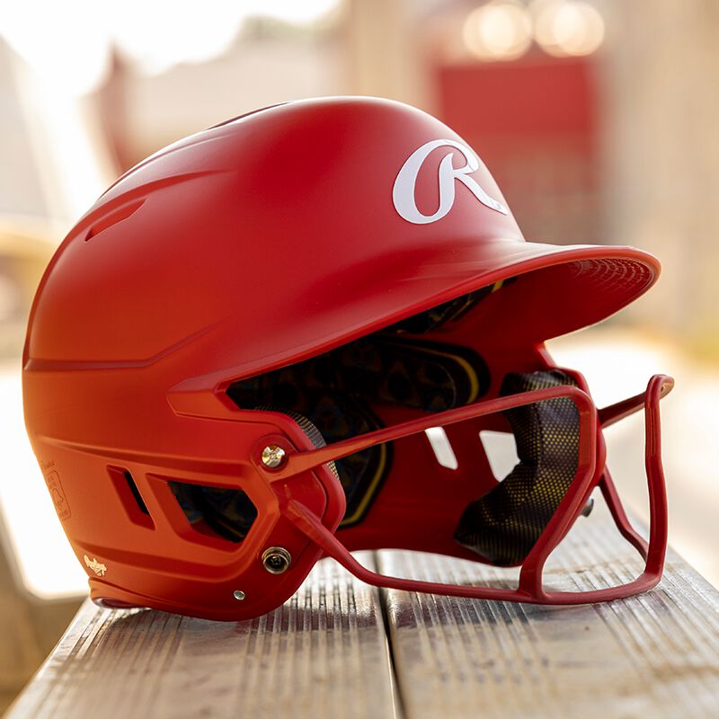 Right side of a scarlet Mach Hi-Viz fastpitch helmet on a bench - SKU: MCHVIZ