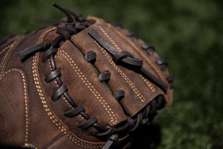 1-Piece solid web of a Player Preferred catcher's mitt on a field - SKU: PCM30