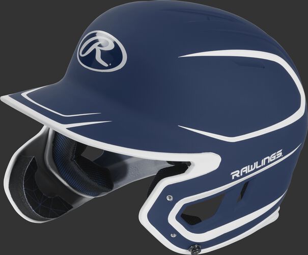 Left angle view of a MACHEXTR Rawlings Mach EXT Junior helmet with a two-tone matte navy/white shell