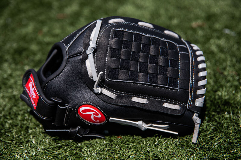 A black RSB infield/outfield Basket web glove lying on a field - SKU: RSB125GB