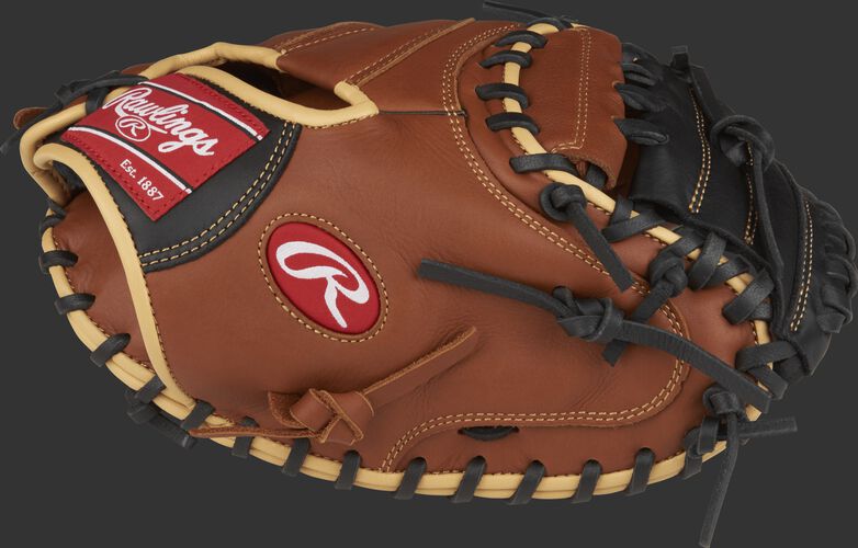 Thumb view of a brown SCM33S 33-inch catcher's mitt with a black One-Piece Solid web