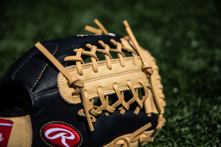 Camel Modified Trap-Eze web on a youth Prodigy glove on a field - SKU: P115CBMT