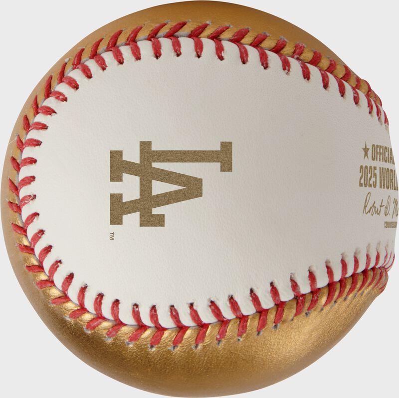 A gold Los Angeles Dodgers logo stamped on the white side of a MLB 2025 Gold World Series dueling baseball loading=
