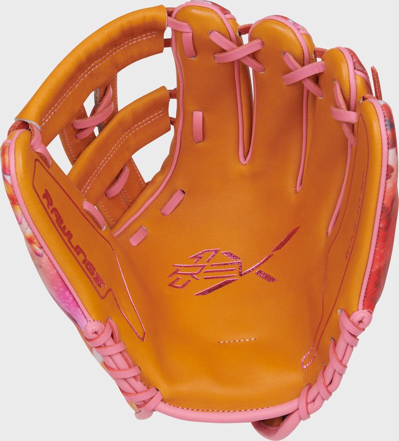 Tan palm of a Rawlings Francisco Lindor REV1X glove with pink laces