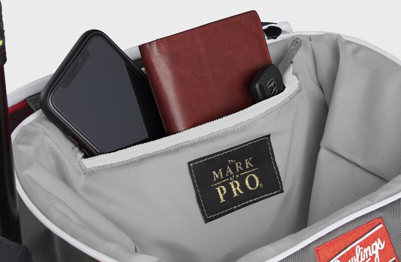 Zippered pocket in the top storage compartment of a scarlet Impulse backpack with a phone, wallet and keys - SKU: IMPLSE-S