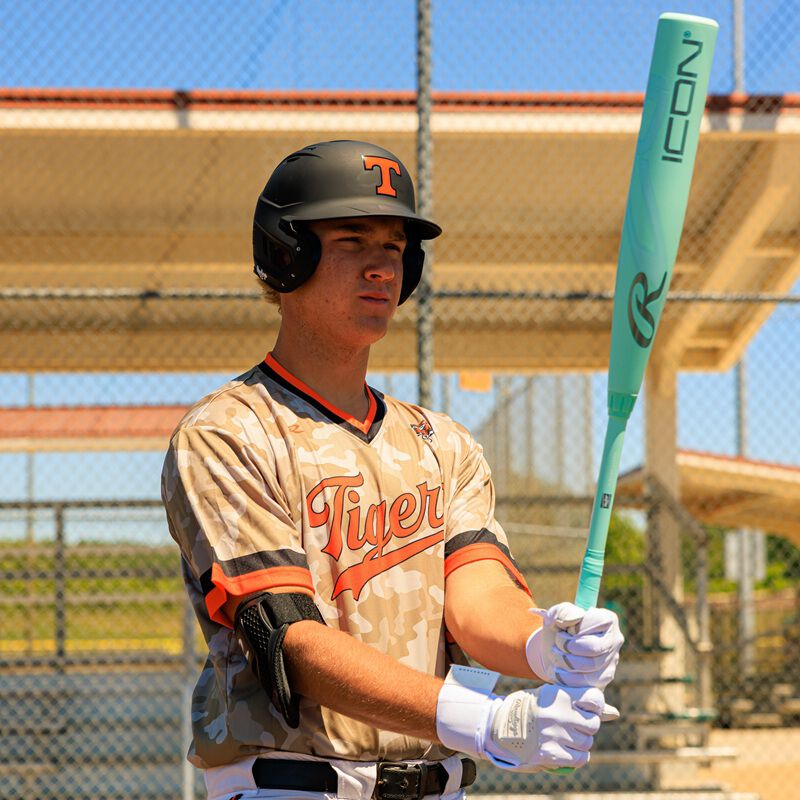 Picture of a player holding a 2026 Rawlings Icon BBCOR bat