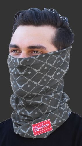 A guy wearing a graphite Rawlings adult multi-functional head and face cover around his mouth and nose - SKU: RC40005-005