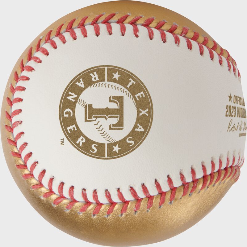 A gold Texas Rangers logo stamped on a Rawlings 2023 World Series champions baseball