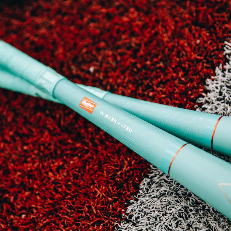 Rawlings patch logo on the handle of a Mach AI bat on a field - SKU: RUT4MC