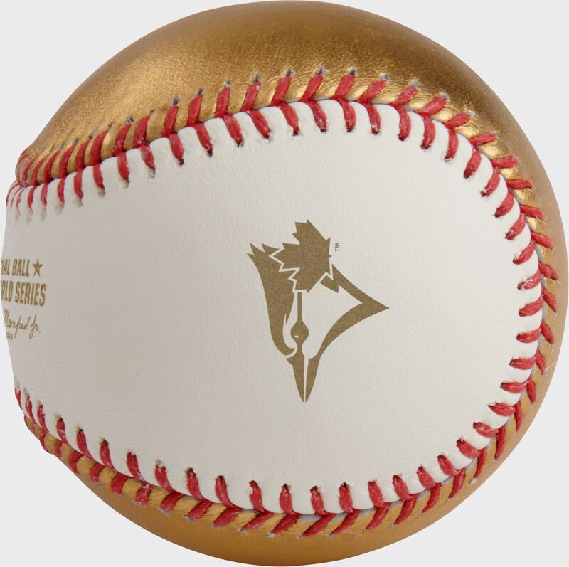 A gold Toronto Blue Jays logo stamped on the white side of a MLB 2025 Gold World Series dueling baseball loading=