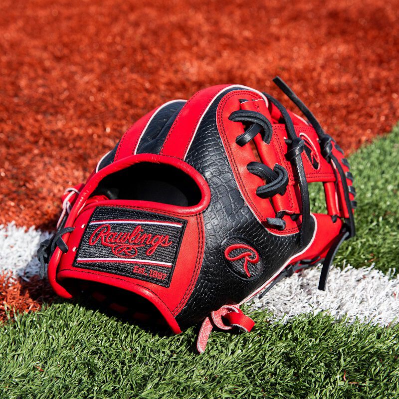 Back thumb of a red/black ColorSync 8.0 Heart of the Hide infield glove on a field
