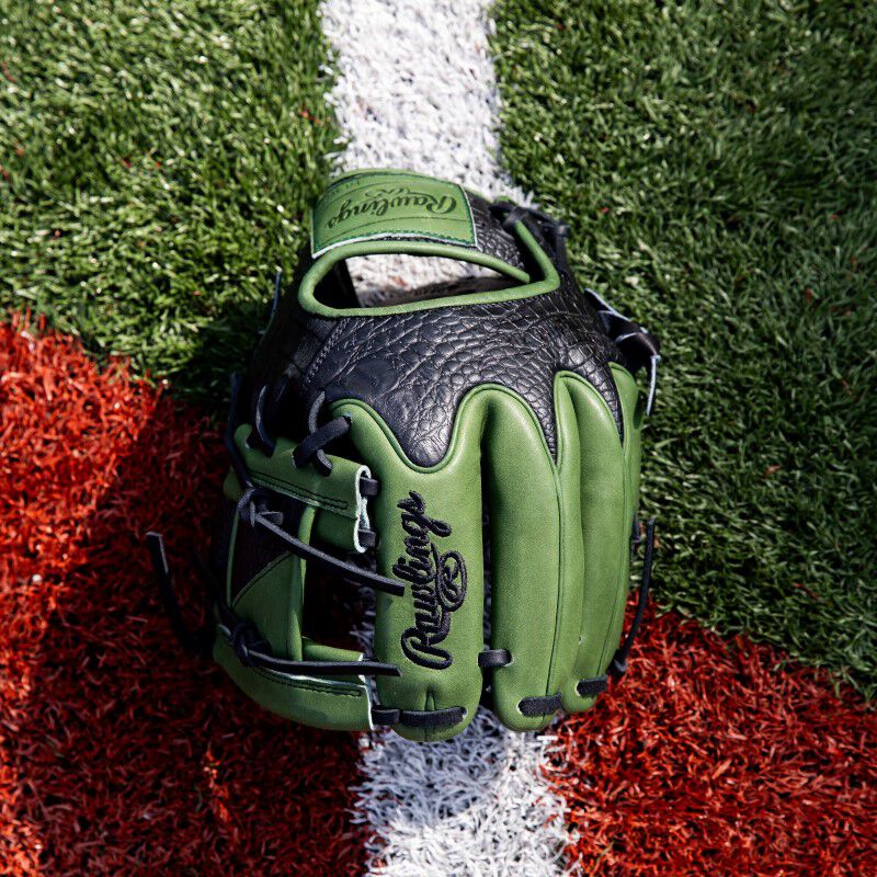 Birds-eye view of a Heart of the Hide ColorSync 8.0 military green infield glove on a field
