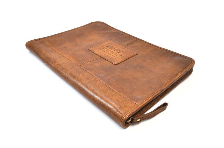Angled view of a tan rugged portfolio with the zipper on the bottom - SKU: V614-202