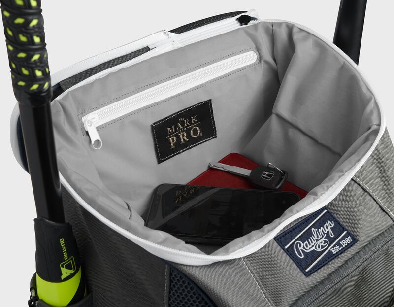 Top compartment of a navy Impulse bag with a phone, keys and black "The Mark of a Pro" patch - SKU: IMPLSE-N