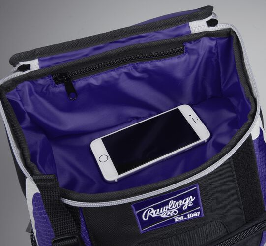 Top accessory pocket of a black/purple R500 equipment backpack holding a phone