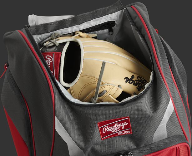 A glove in the dedicated glove storage pocket of a Rawlings Legion equipment backpack - SKU: LEGION-S