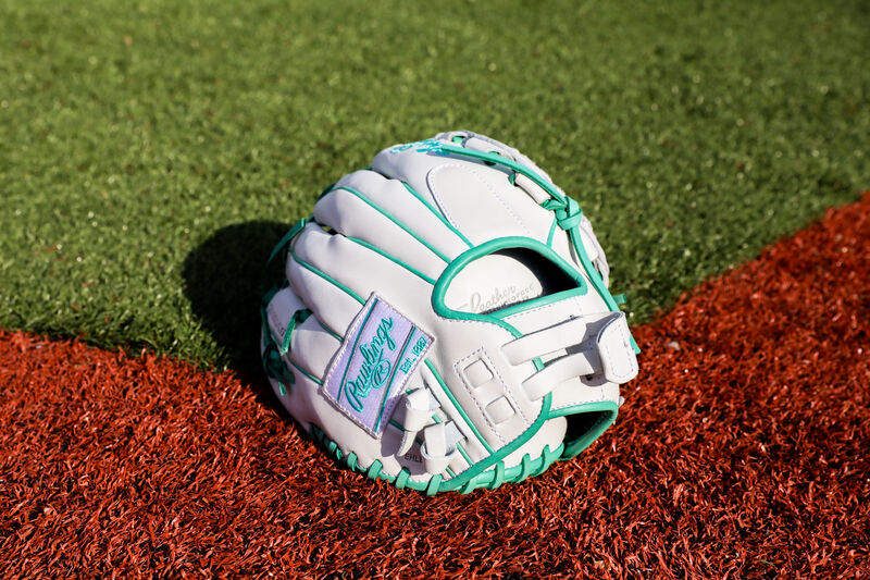 Back of a white/mint  Liberty Advanced Color Series infield/pitcher's glove on a field - SKU: RLA120-3WM