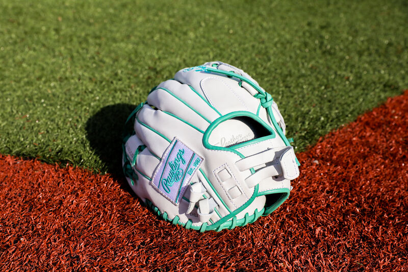 Back of a white/mint  Liberty Advanced Color Series infield/pitcher's glove on a field - SKU: RLA120-3WM loading=