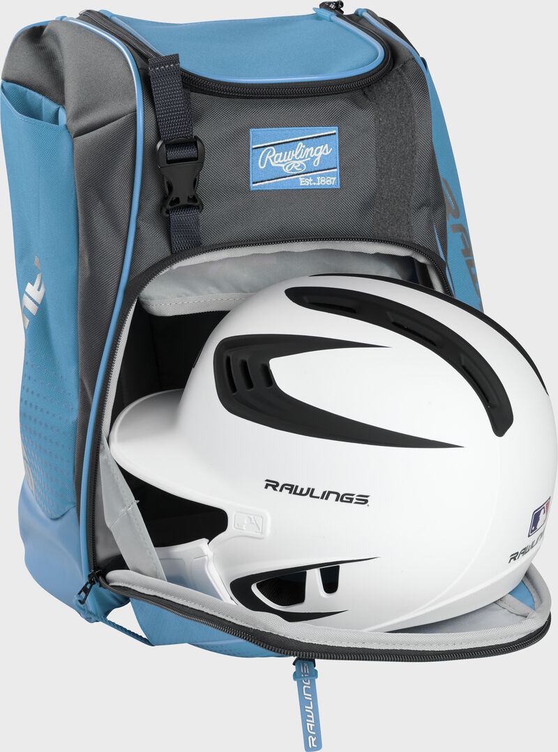 A white/black helmet in the main compartment of a Columbia blue Rawlings Franchise backpack - SKU: FRANBP-CB