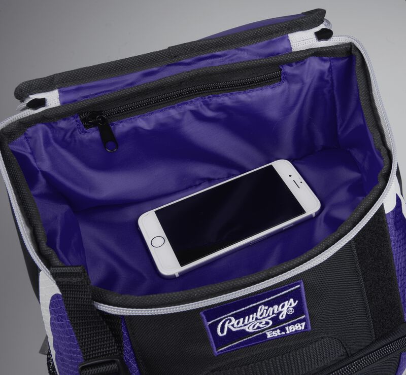 Top accessory pocket of a black/purple R500 equipment backpack holding a phone