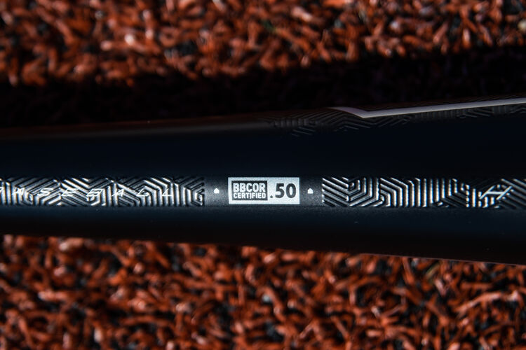 BBCOR stamp on a Rawlings 2020 Velo ACP high school/college bat lying on a field - SKU: BBZV3
