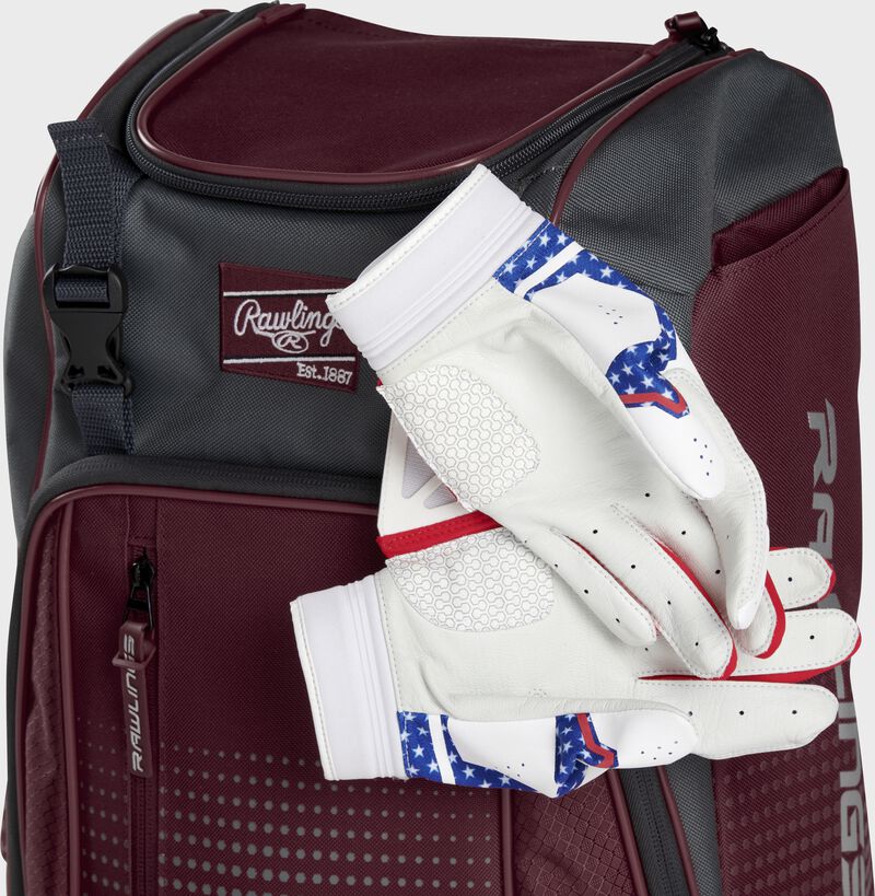 Two batting gloves hanging on the front Velcro strap of a Franchise baseball backpack - SKU: FRANBP-MA