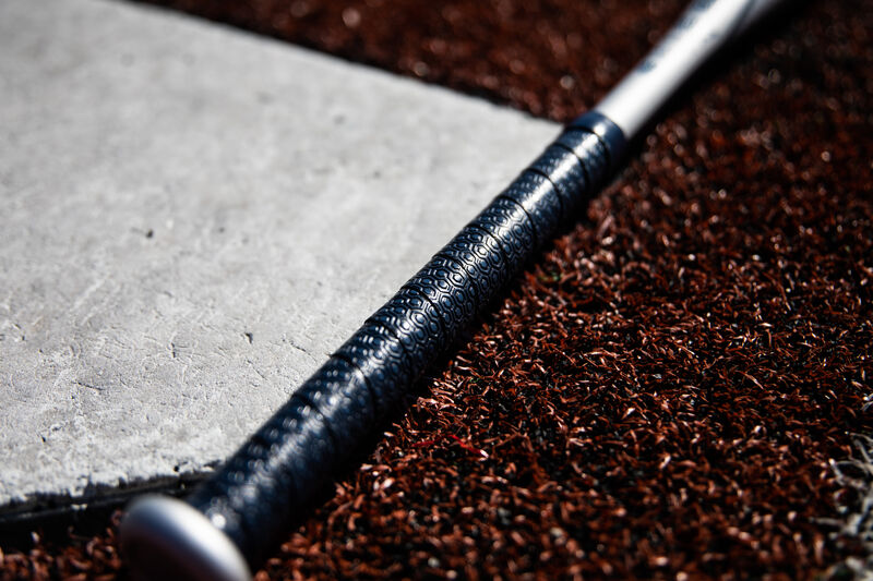 Navy blue batting grip of a Rawlings Storm fastpitch bat next to home plate - SKU: FPZS13