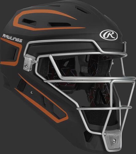Front right of a black/orange CHV27J Rawlings Velo 2.0 catcher's helmet
