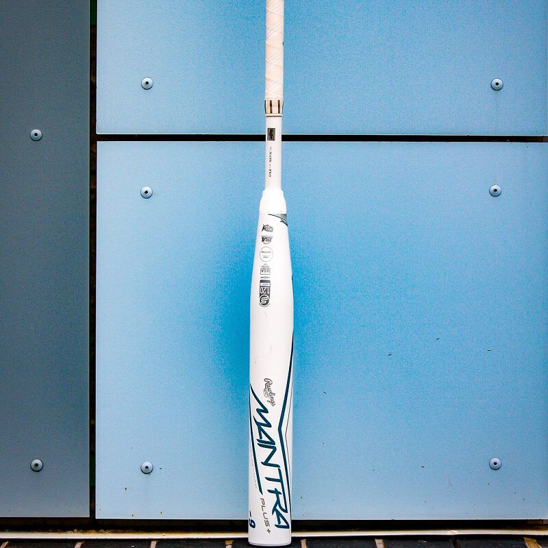 A white 2023 Rawlings Mantra+ fastpitch bat leaning against a wall - SKU: RFP3MP