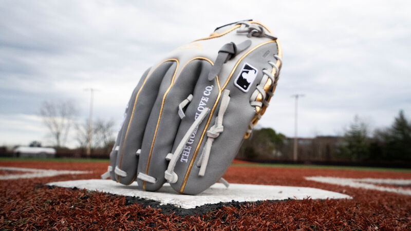 A HOH Wing Tip infield glove standing on its finger tips on home plate - SKU: PRO204W-2GW
