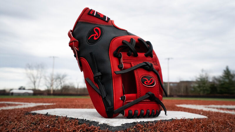 A scarlet/black HOH Speed Shell exclusive I web glove standing up on home plate of a field - SKU: PRO315-2SSS