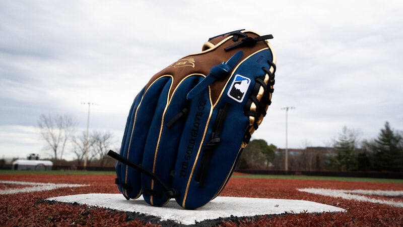 An exclusive HOH Wing Tip infield glove standing up on home plate on the finger tips - SKU: PRO204W-2TIR loading=
