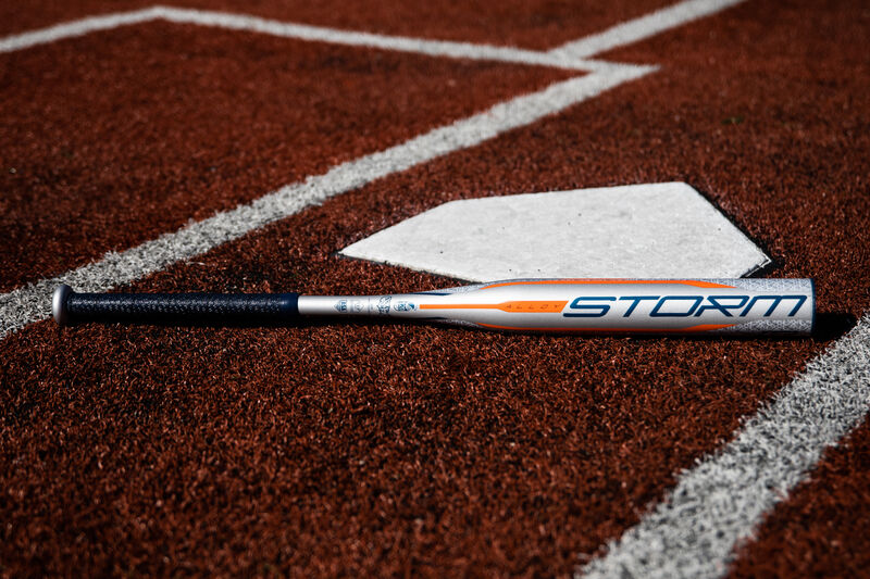 A silver Rawlings 2020 Storm bat lying on a field next to home plate - SKU: FPZS13