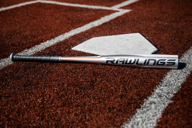 A silver Rawlings 5150 baseball bat lying on a field at home plate - SKU: BBZ53