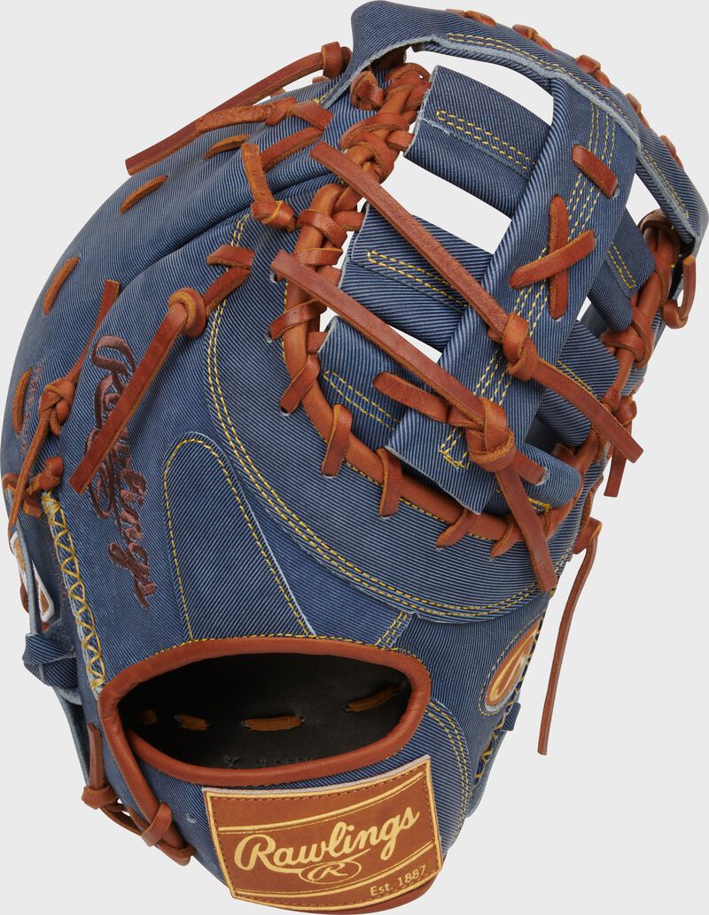 Back of a Heart of the Hide Pro Label Denim 1st base mitt with a tan leather Rawlings patch