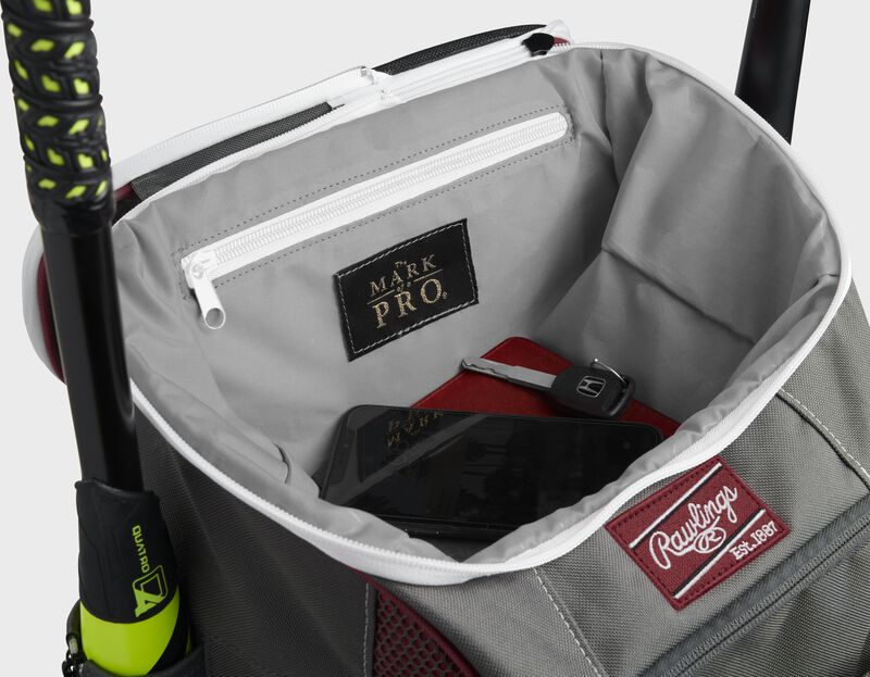 Top compartment of a cardinal Impulse bag with a phone, keys and black "The Mark of a Pro" patch - SKU: IMPLSE-C