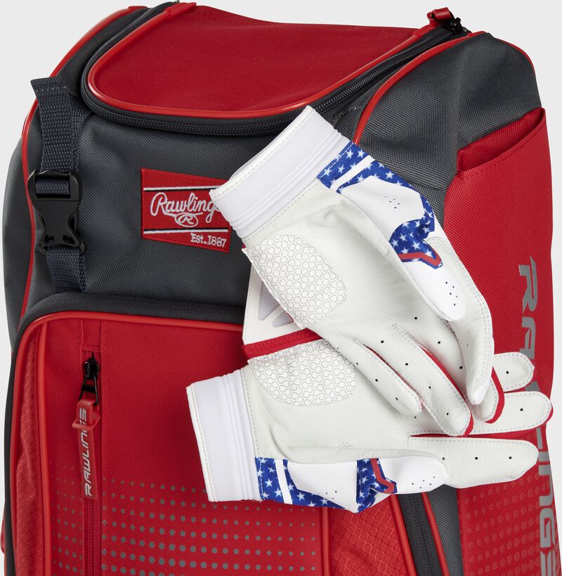 Two batting gloves hanging on the front Velcro strap of a Franchise baseball backpack - SKU: FRANBP-S