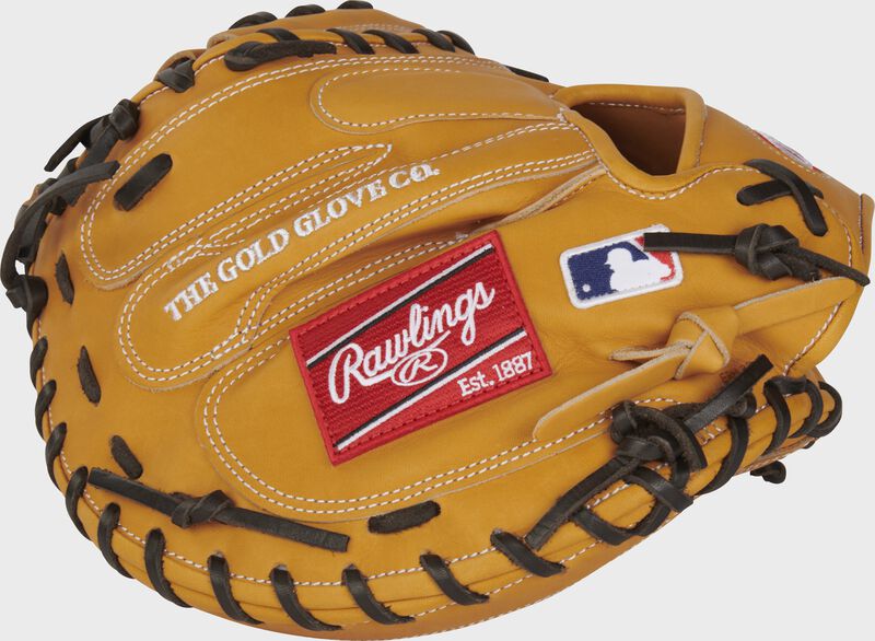 Back of a tan Heart of the Hide catcher's mitt with a red Rawlings patch and MLB logo on the pinky side - SKU: PROTCM33T
