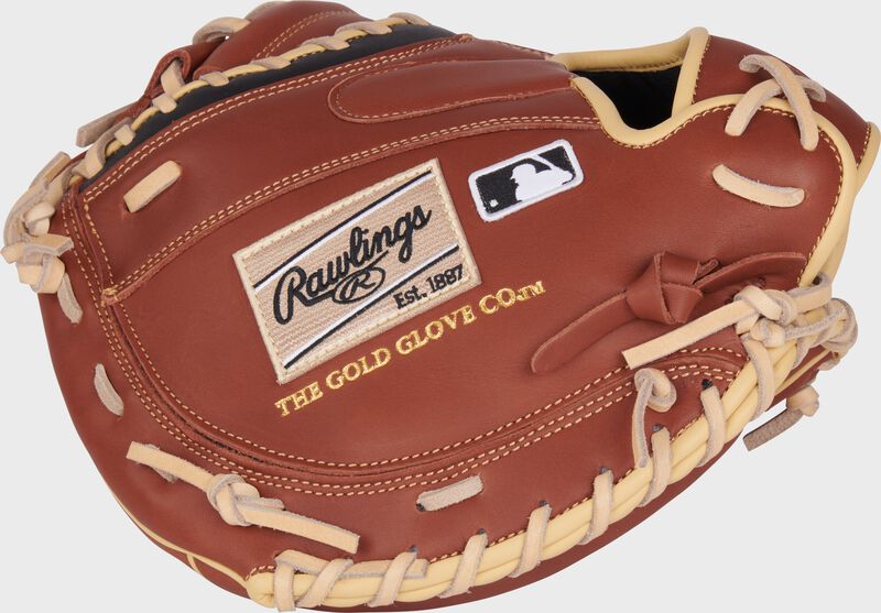 Dark brown back of a NXT Series 32.5" catcher's mitt with a camel Rawlings patch and MLB logo
