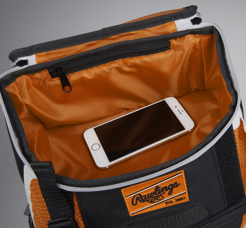 Top accessory pocket of a black/orange R500 equipment backpack holding a phone