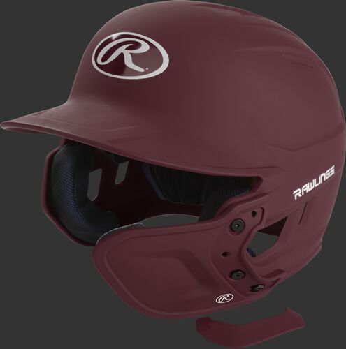 A maroon MEXTR attached to a Mach batting helmet with the removable TPU piece off to show the hardware