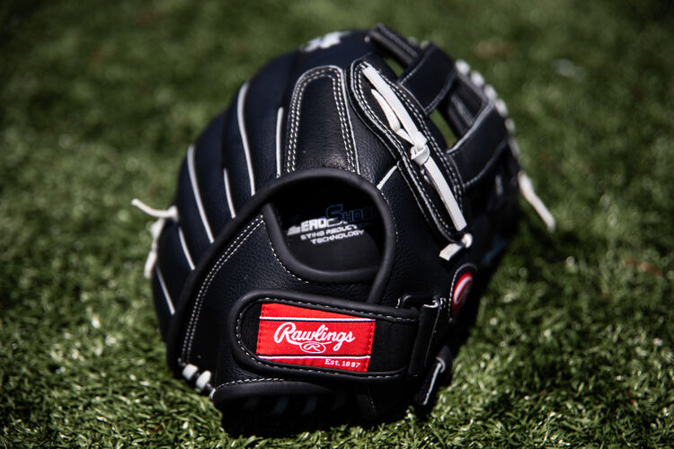 Rawlings patch on the wrist strap of a RSB recreational glove lying on a field - SKU: RSB130GBH