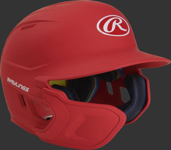 Right angle view of a matte scarlet MACHEXTL Mach Senior helmet with Mach EXT left hand batter face guard extension
