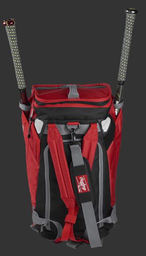 A scarlet R601 Rawlings Hybrid duffel/backpack standing up with two bats