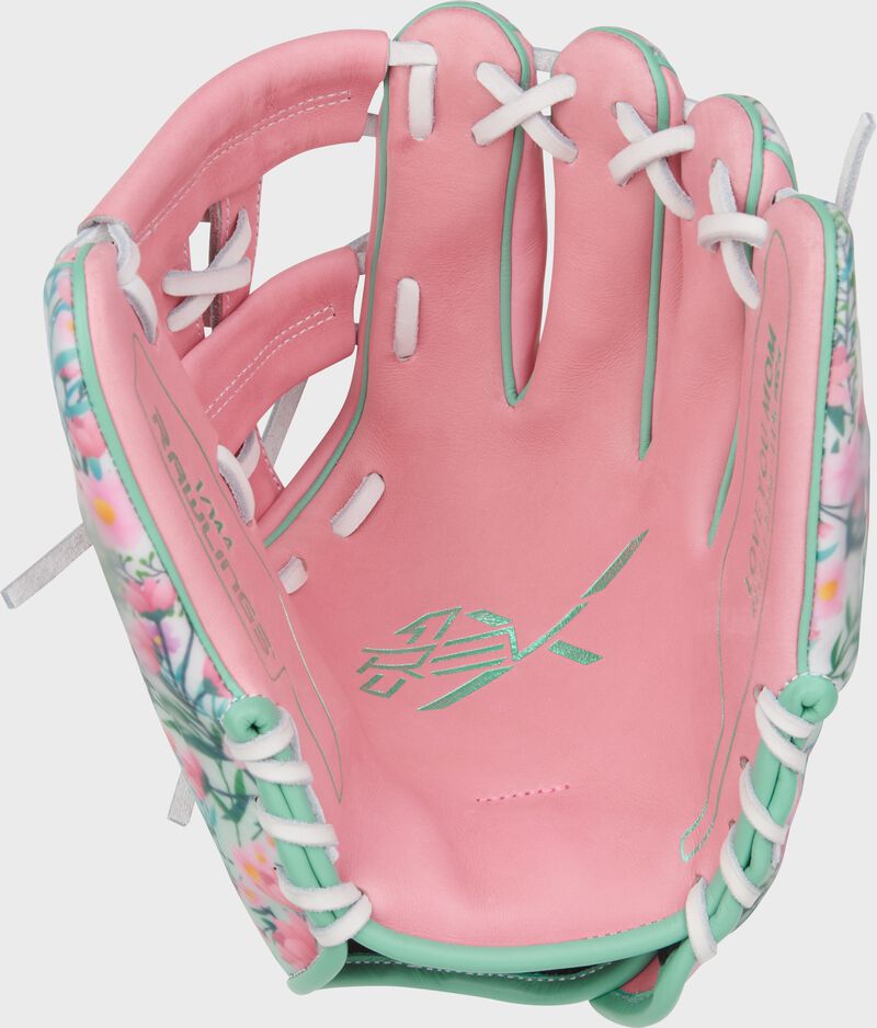 Pink leather palm of a Rawlings Mother's Day REV1X glove with white laces