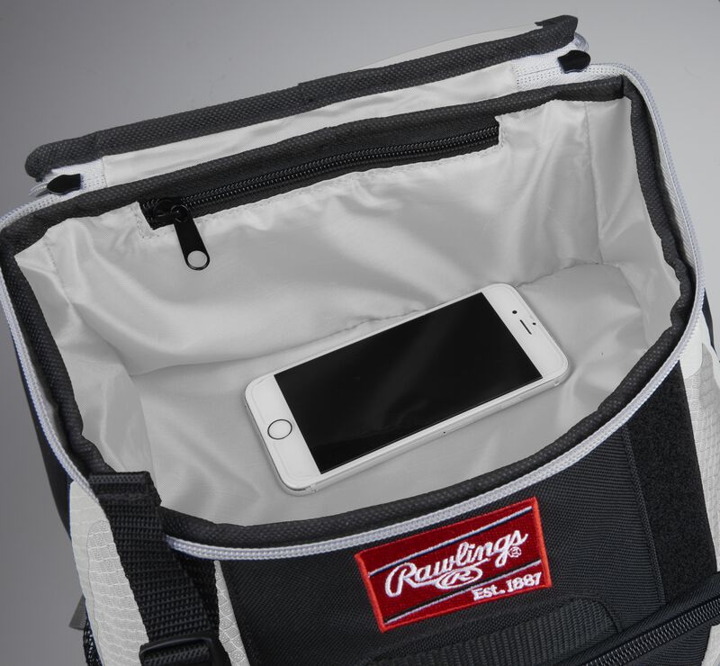 Top accessory pocket of a black/white R500 equipment backpack holding a phone