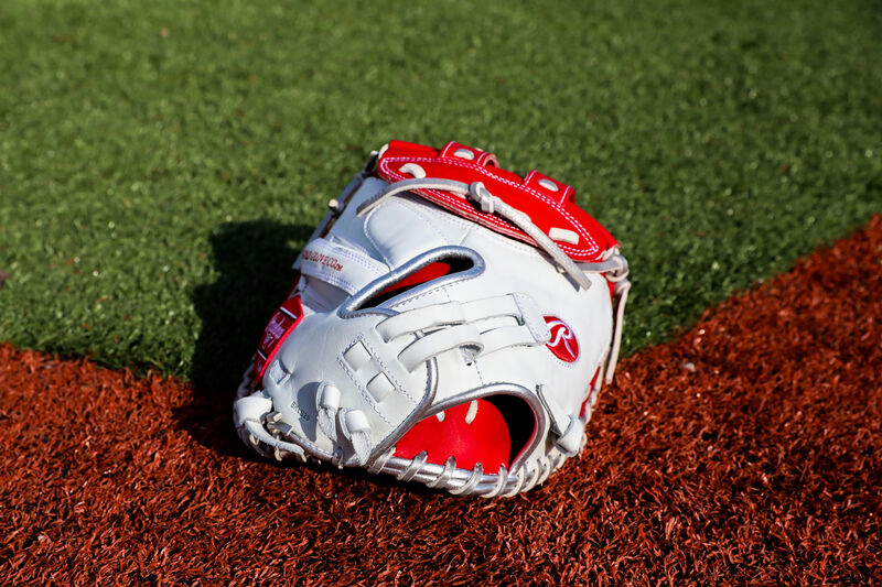 Back of a white/scarlet Liberty Advanced Color Series catcher's mitt on a field - SKU: RLACM34FPWSP