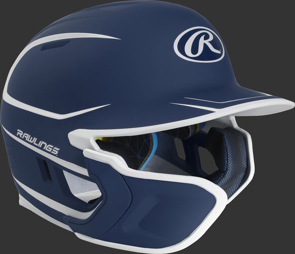 Right angle view of a matte navy/white MACHEXTR Mach Junior helmet with Mach EXT left hand batter face guard extension